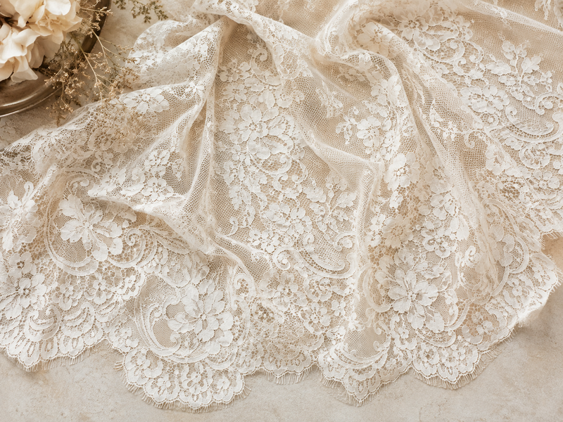 Fine Brussels lace in ivory with floral motifs for dressmaking and decorative sewing