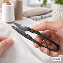 Black thread snips trimming a loose thread