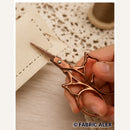 Bronze ornate embroidery scissors in use - Fabric Alex