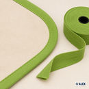 Lime green 20 mm cotton bias binding sewn onto a curved fabric edge
