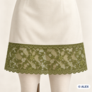 Green floral vine elastic lace used as a dress hem