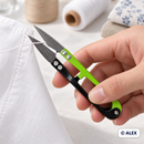 Green and black thread snips trimming a loose thread