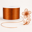 Orange jewellery wire 0.5 mm shown in a decorative wire flower example