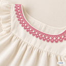 Pink Brussels lace used as decorative dress neckline edging