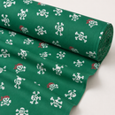 Pirate skulls on green printed polycotton fabric