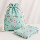 Unicorn and pink star polycotton fabric shown as a drawstring pouch