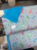 Dinosaur print waterproof fabric with soft blue backing, 150 cm wide
