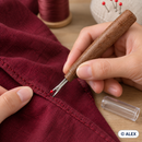Wood-effect handle seam ripper removing a stitch